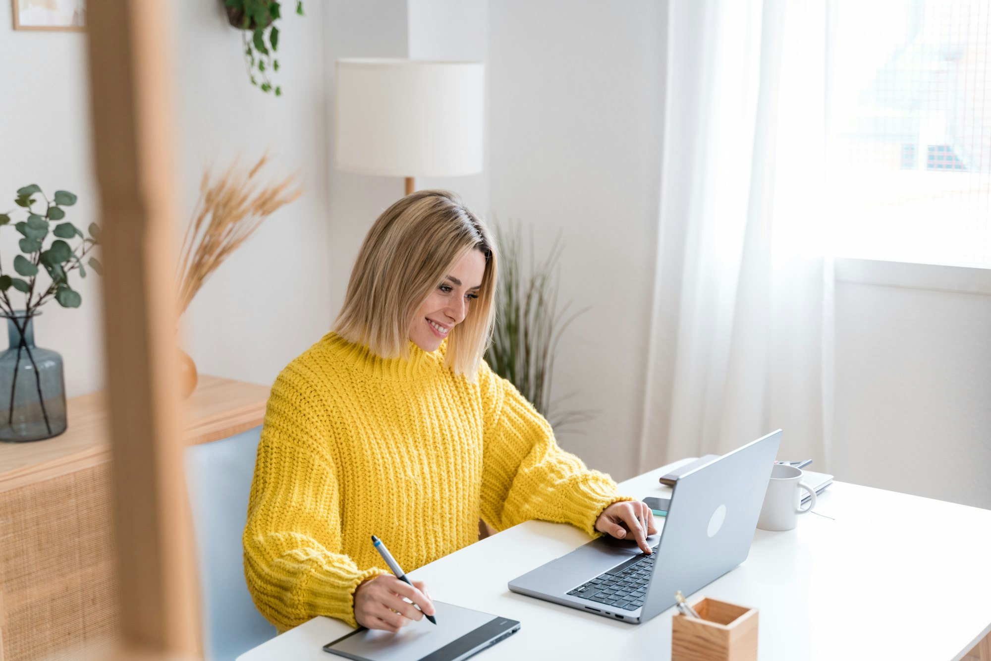 Focused woman working on laptop at home