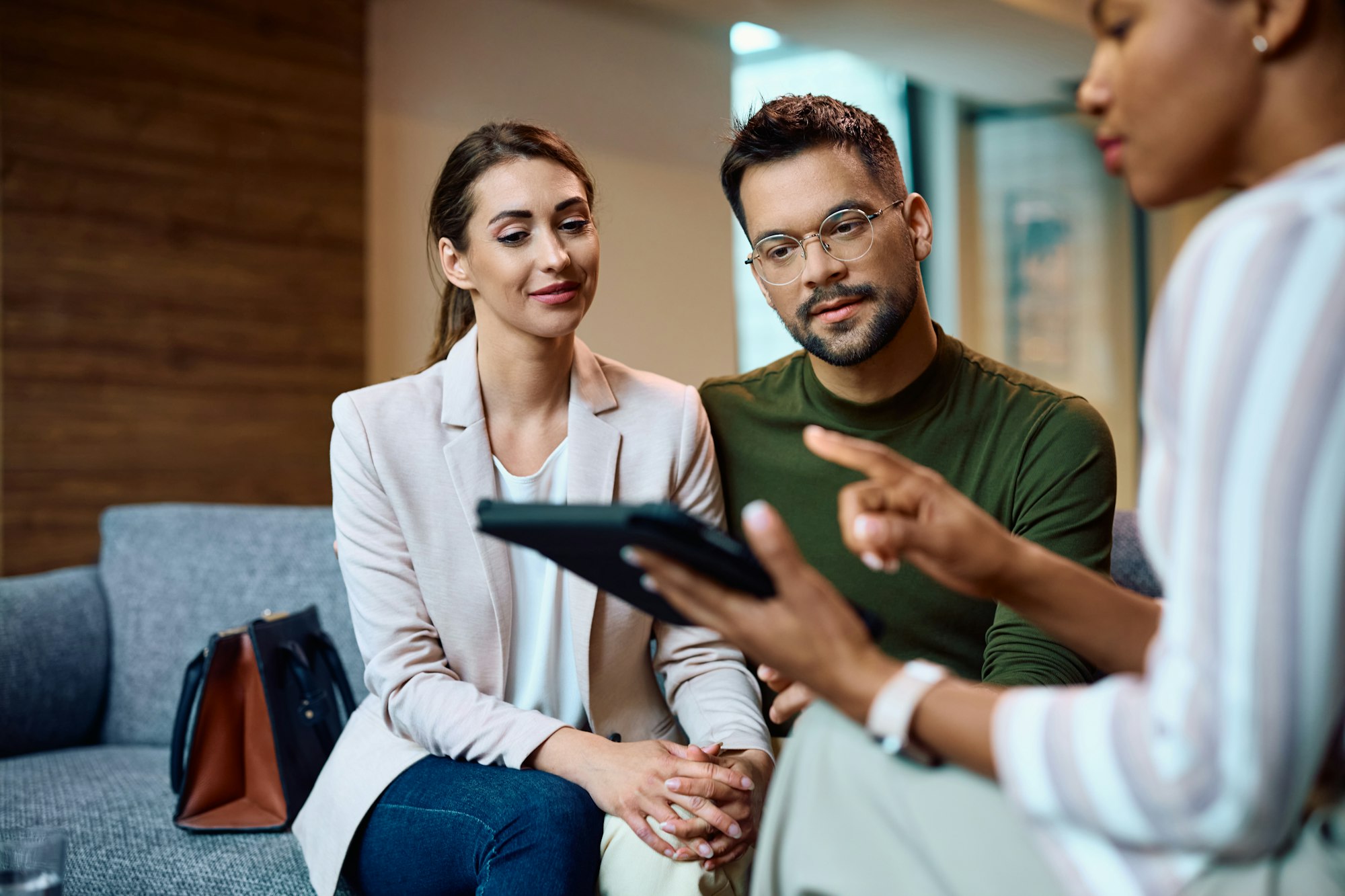 Young couple consulting with their insurance agent in the office.
