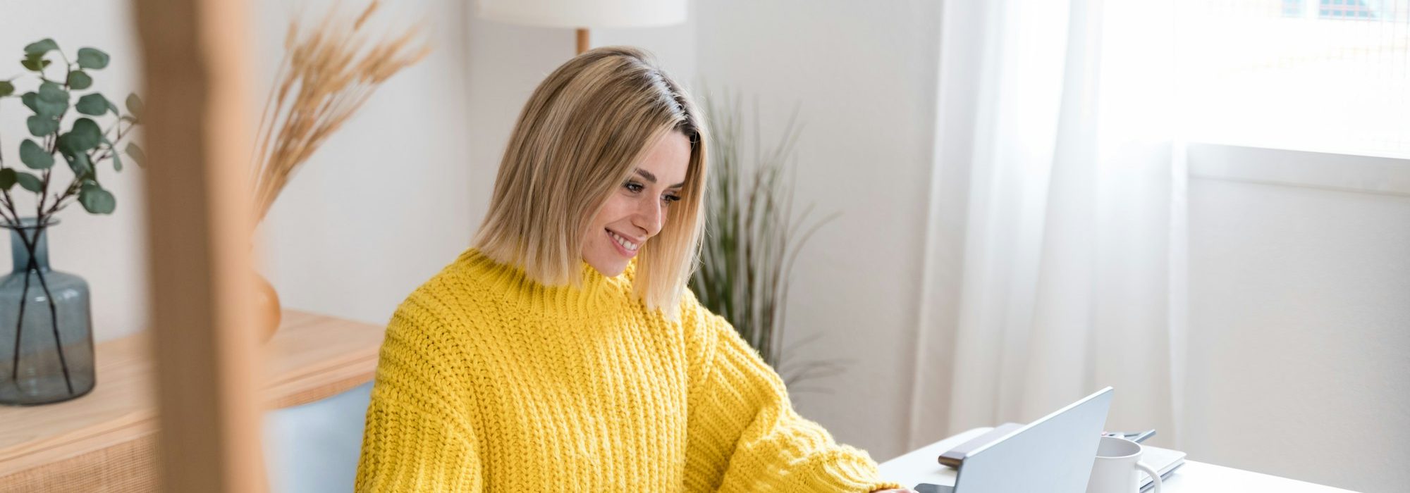 Focused woman working on laptop at home
