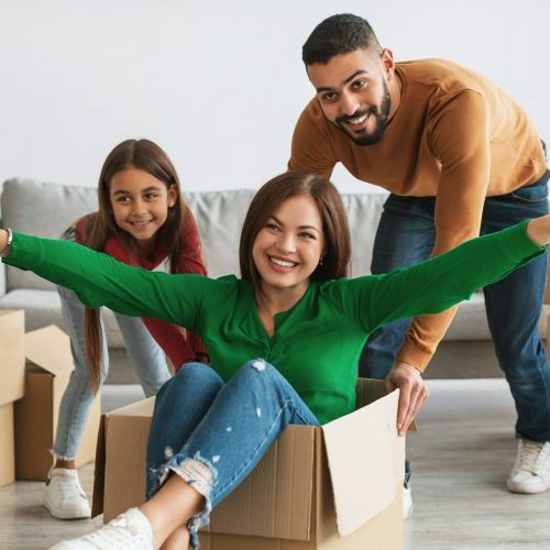 Happy family celebrating moving day in new apartment