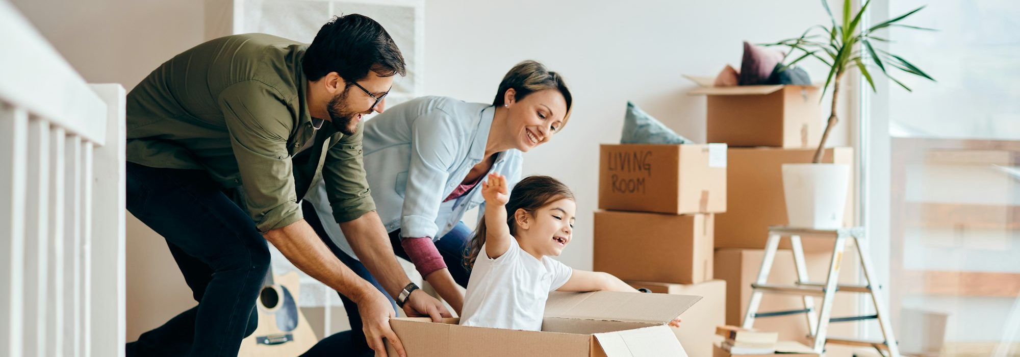 Playful family having fun while relocating in their new house.